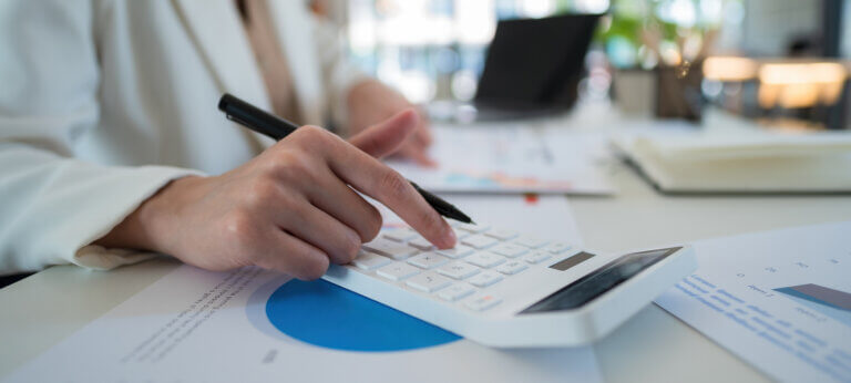 A woman working with a pen and calculator