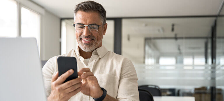 Man working on his phone with is online business.