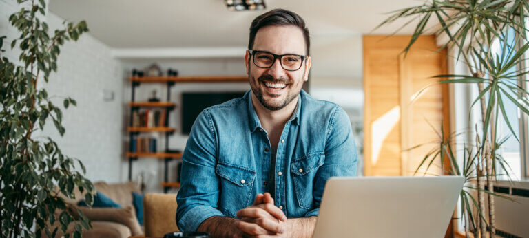 Portrait of a happy freelancer at home office.