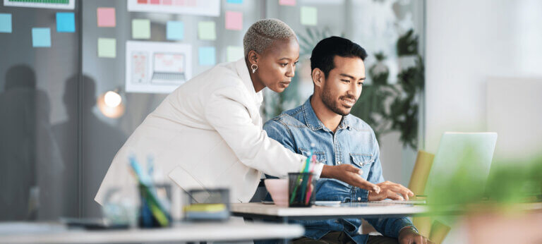 Man and woman looking at a profit and loss statement on a computer