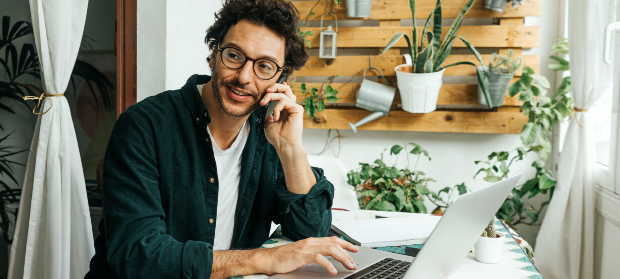 A man in his home office using an invoice generator for Word