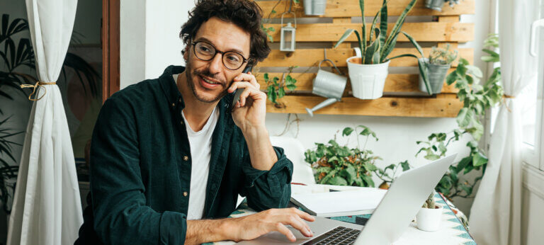 A man in his home office using an invoice generator for Word