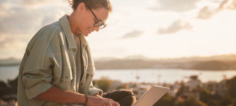 A woman making an invoice on her laptop using a free invoice generator