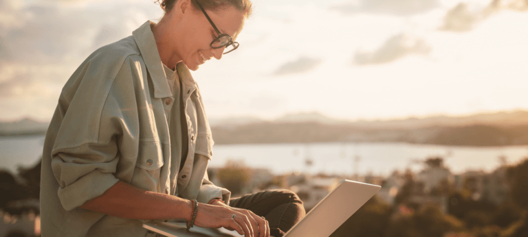 A woman making an invoice on her laptop using a free invoice generator