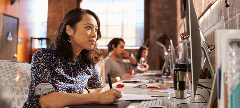 A woman working on her laptop in a coworking space