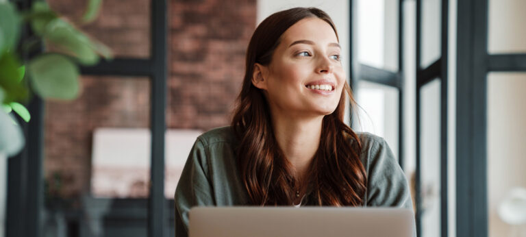 A smiling woman making a Figma invoice