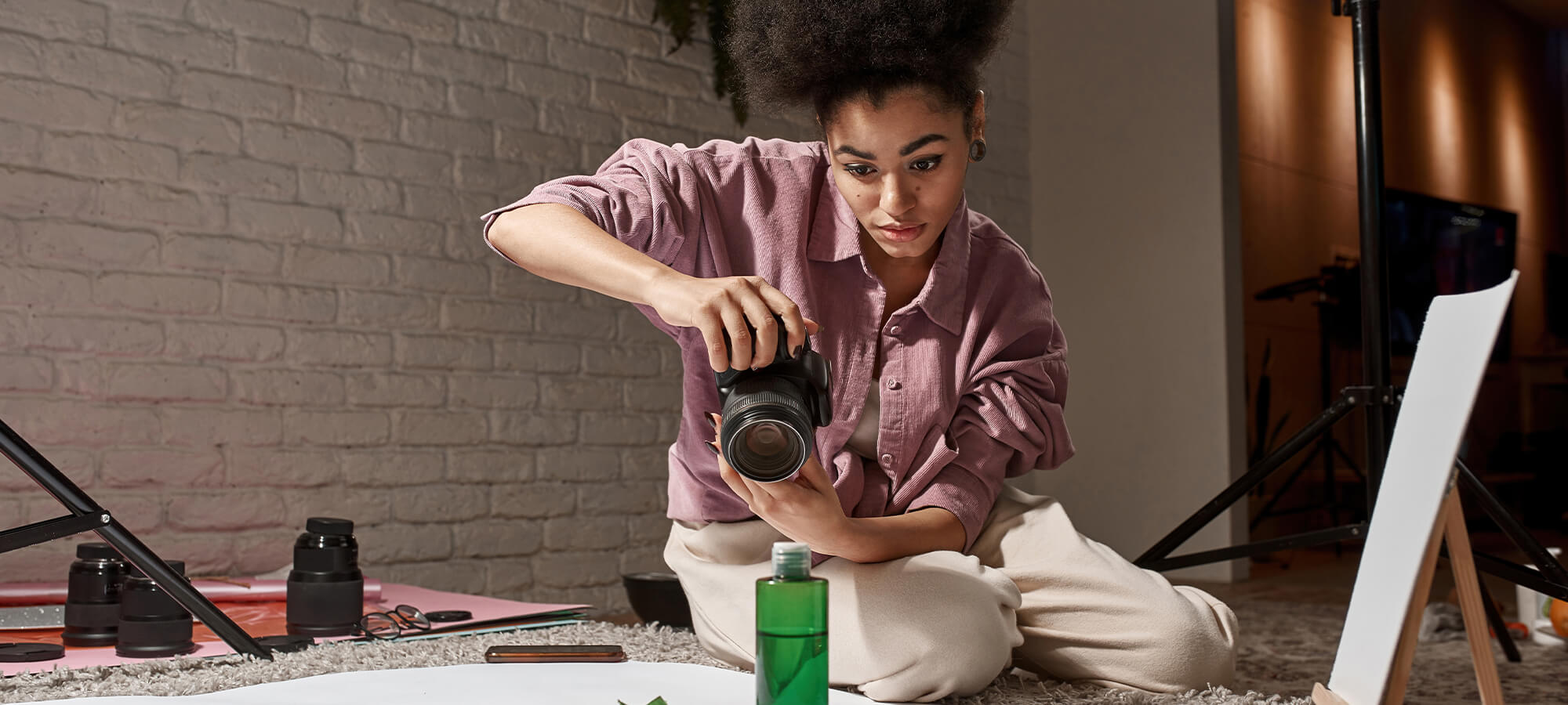 A woman taking photographs in her apartment, hobby or business?