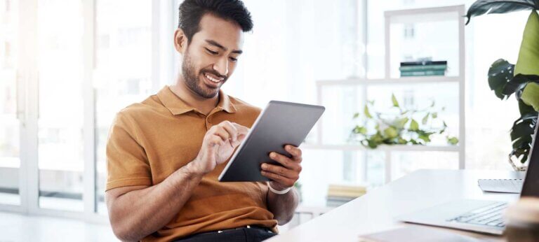 A man making a sample cash flow statement on an iPad