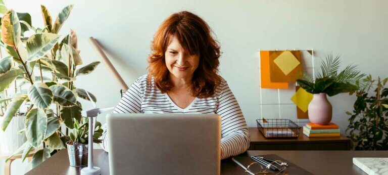 A woman reading about whether an invoice is the same as a bill