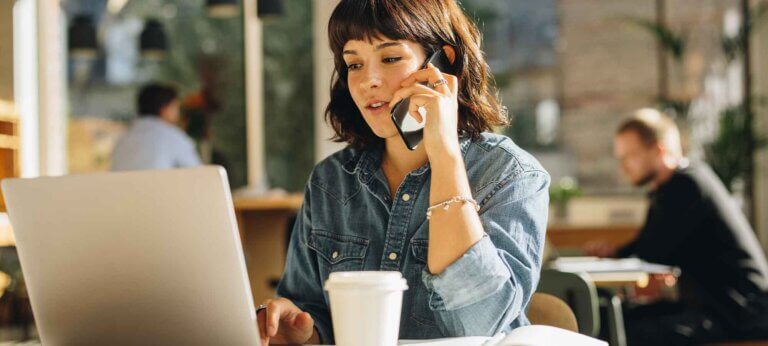 A woman looking at invoice examples on her laptop